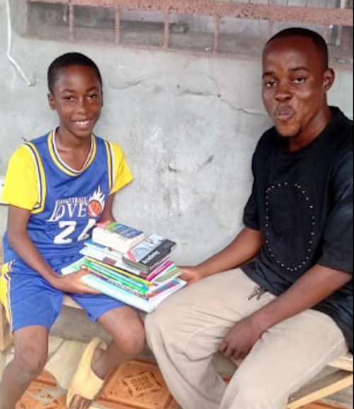 Gideon with volunteer Alusine