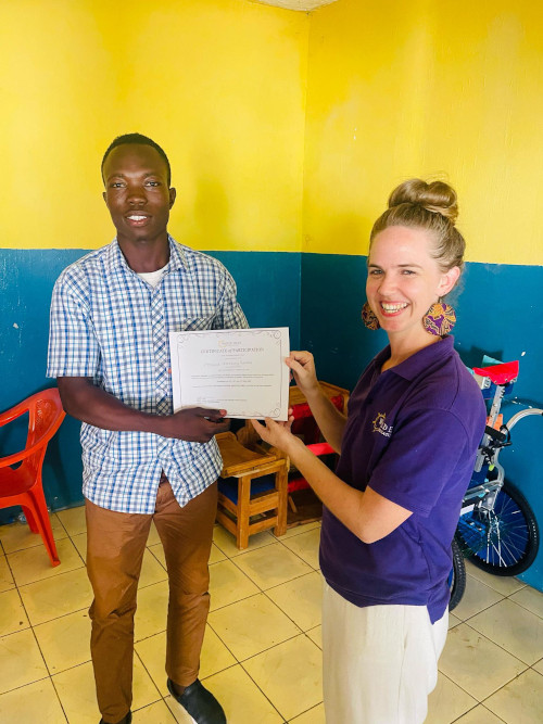 Mohamed receiving certificate for disability training