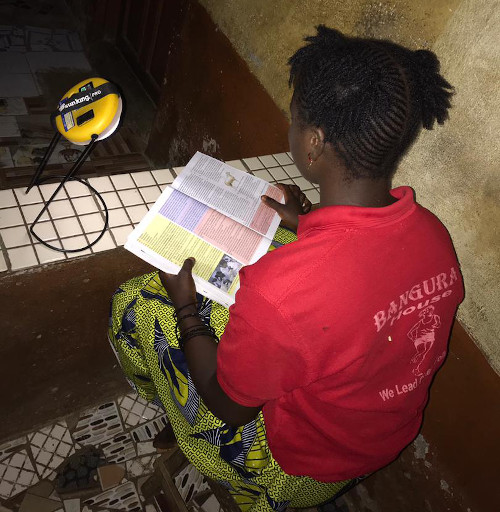 Sierra Leone annual report 2024 girl with solar light known to Alusine used for carbon offset